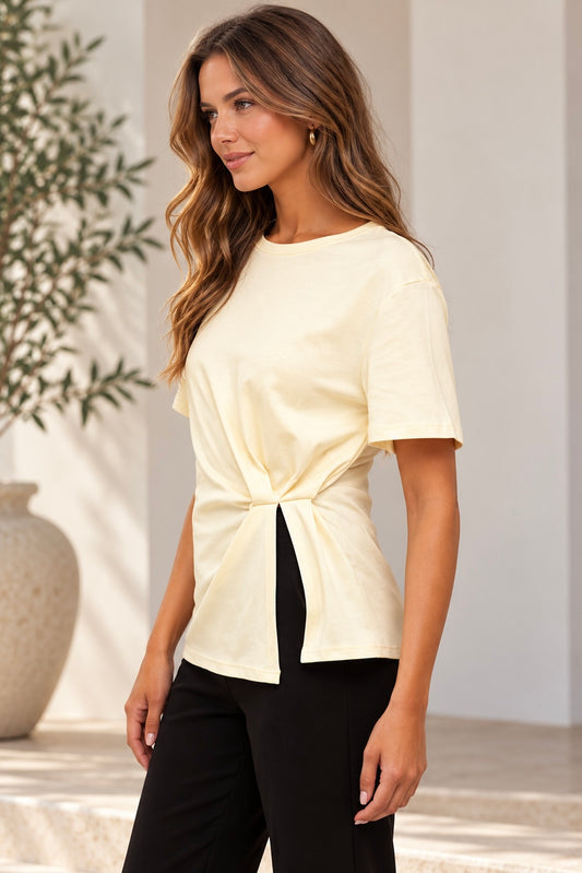 Close-up of the front pleat and split hem detail on the butter Mood Tee