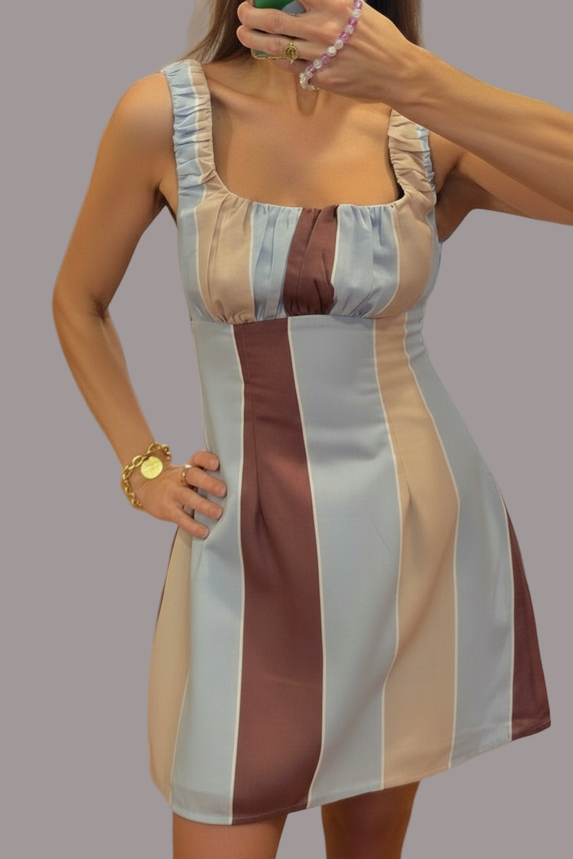 Woman wearing a striped dress in a store setting