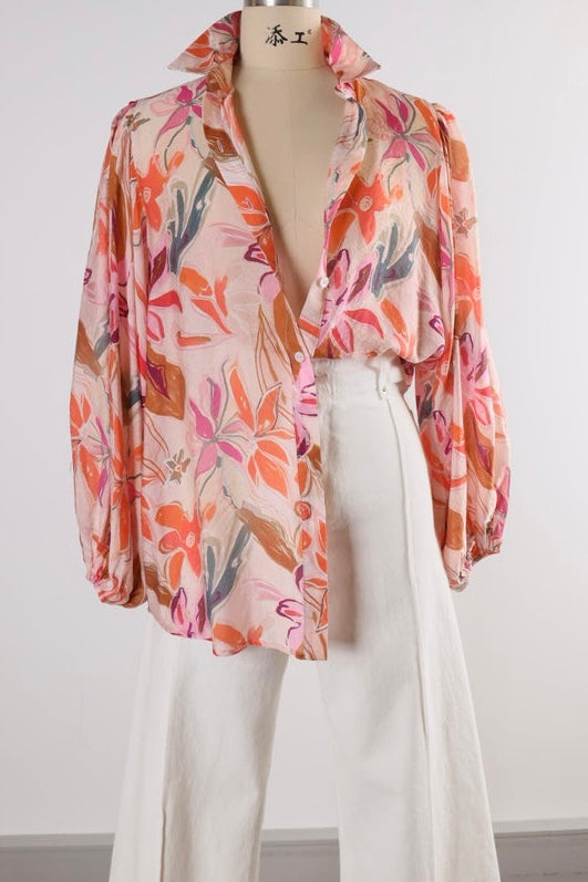 Floral patterned shirt with white pants against 