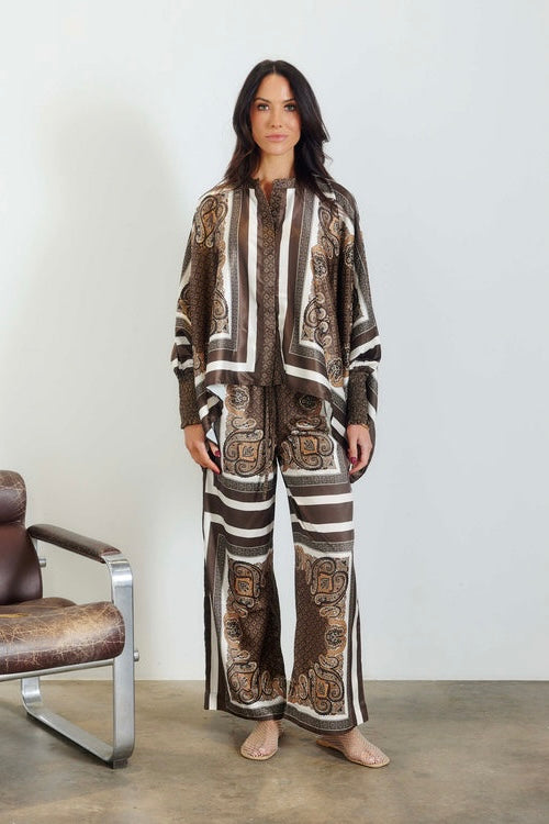 Taormina Scarf Pant — full length front view of relaxed wide-leg pant in chocolate and ivory paisley border print, styled with matching batwing top, white studio background