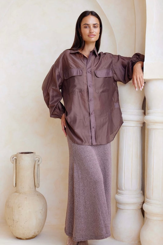 Woman wearing a sheer chocolate shirt and skirt by jatea the label