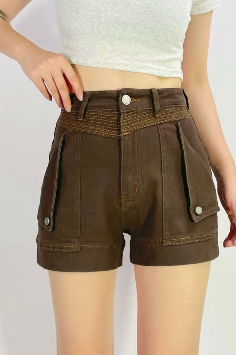 stretch denim Brown shorts with white buttons on a plain background