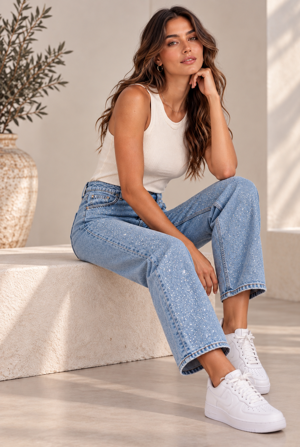 A woman modeling the Diamond Jeans, high-waist sequin denim, paired with a top