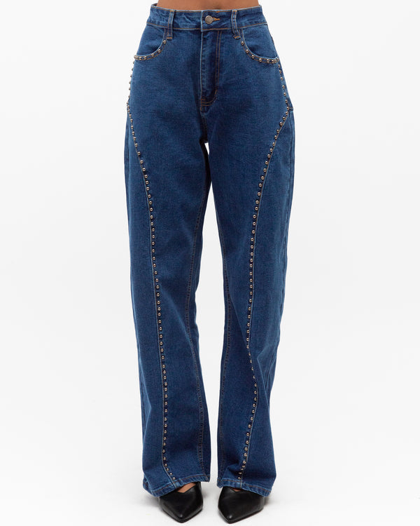Blue high rise jeans with stud detail down the legs by paper heart  on a white background